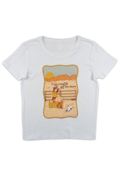 White t-shirt with a graphic design of a girl cryng by a fence with text that reads "Even Cowgirls get the blues" on a white background