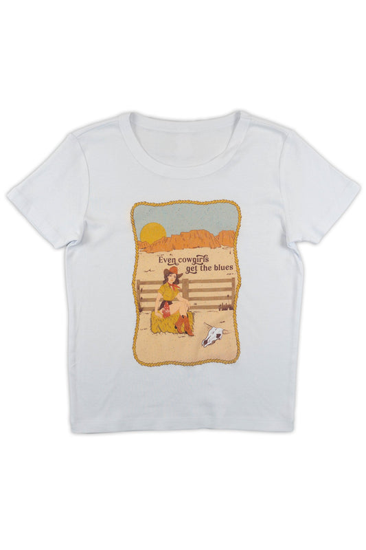 White t-shirt with a graphic design of a girl cryng by a fence with text that reads "Even Cowgirls get the blues" on a white background