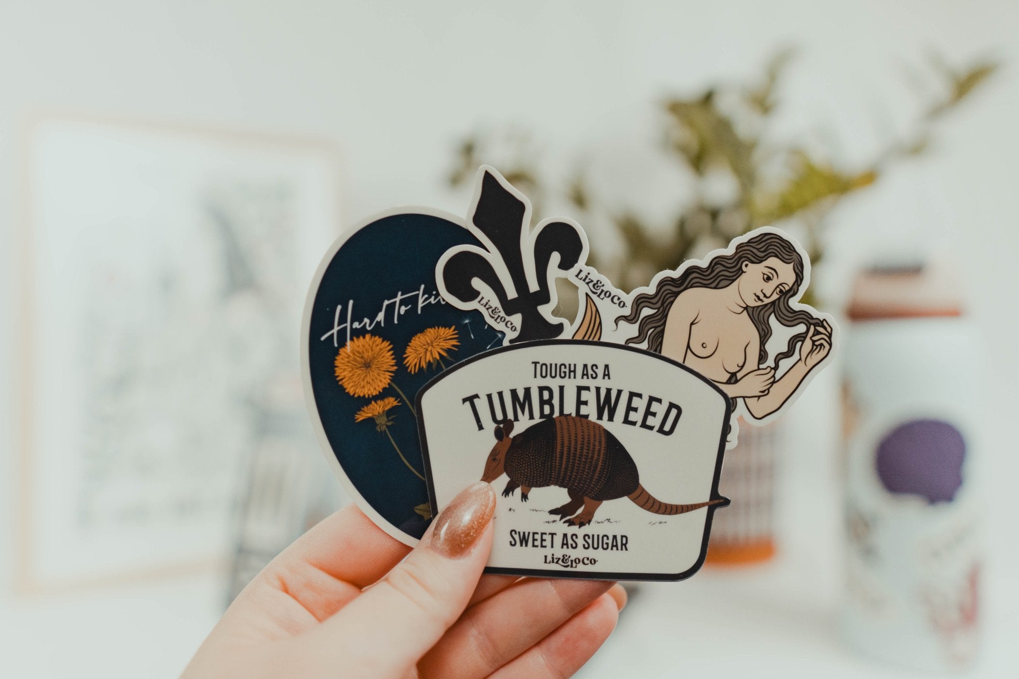 Hand holding a multitude of stickers