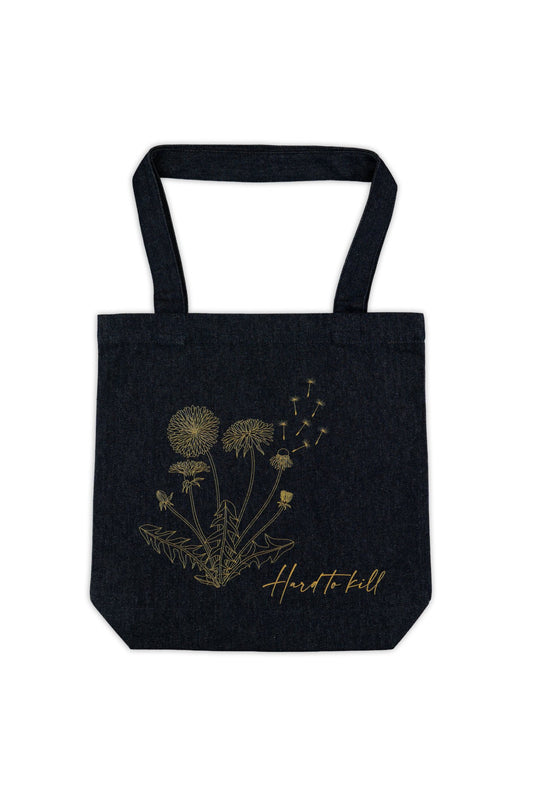 Blue denim tote bag with dandelion design and 'Hard to Kill' text on a white background