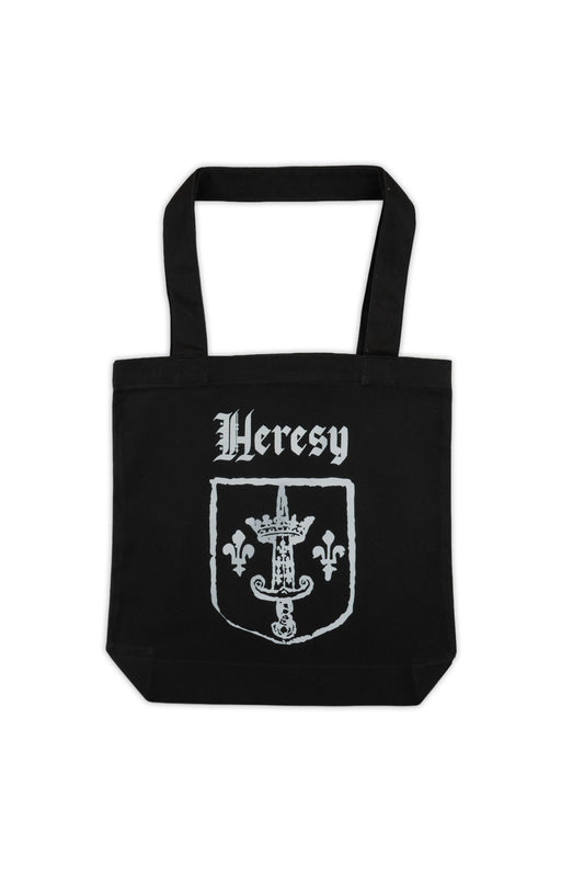 Black tote bag with 'Heresy' text and emblem on a white background