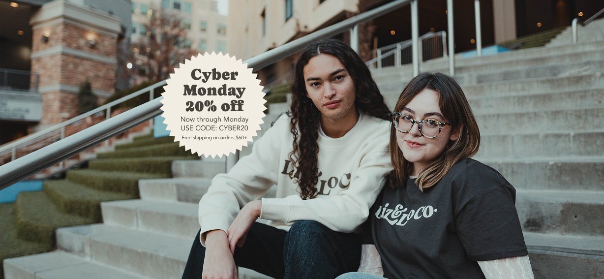 Two people sitting on steps with a Cyber Monday discount overlay.